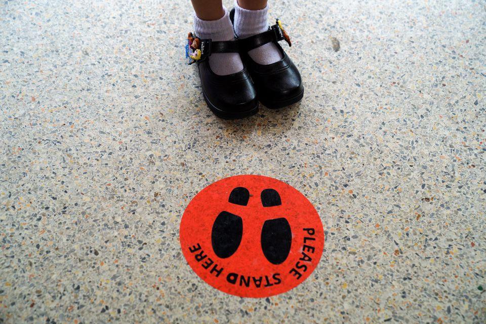 A kindergarten student from Wichuthit school stands next to the mark during a rehearsal social distancing and measures to prevent the spread of the coronavirus disease (COVID-19) ahead of schoold reopening in Bangkok, Thailand, June 23, 2020. - Avaz