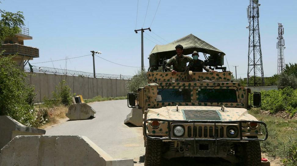 Afghan soldiers stand guard at a road checkpoint outside Bagram Air Base, after all US and NATO troops left - Avaz