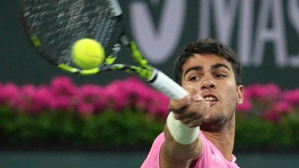 Carlos Alcaraz, of Spain, returns a shot to Thanasi Kokkinakis, of Australia, at the BNP Paribas Open tennis tournament Saturday, March 11, 2023 - Avaz