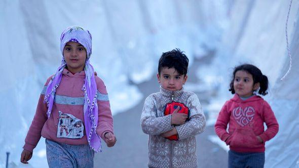 Children walk between tents, in Aslanli, southeastern Turkey, Thursday - Avaz